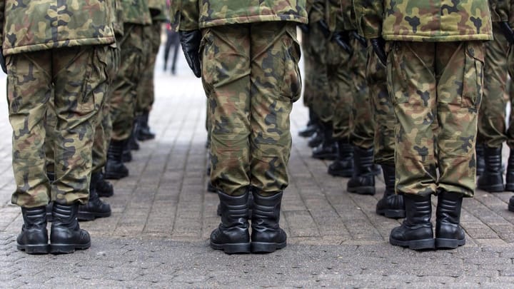 Military troops in camouflage uniforms standing in formation during Trump’s deployment of the National Guard to Los Angeles protests.