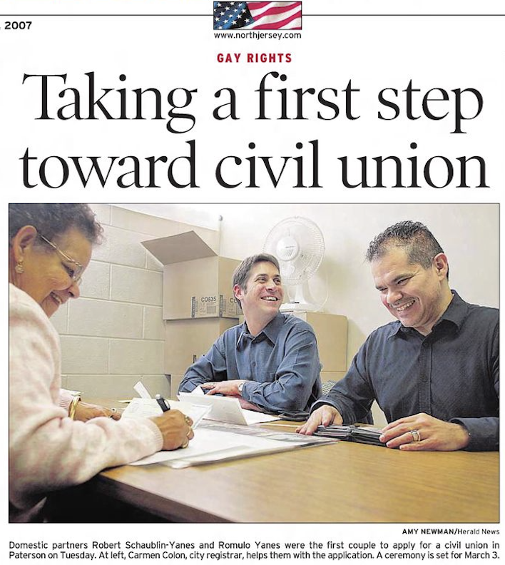 Robert Schaublin-Yanes and Romulo Yanes applying for a civil union in Paterson, NJ, in 2007—smiling at a desk as the first registered same-sex couple in their hometown’s history.